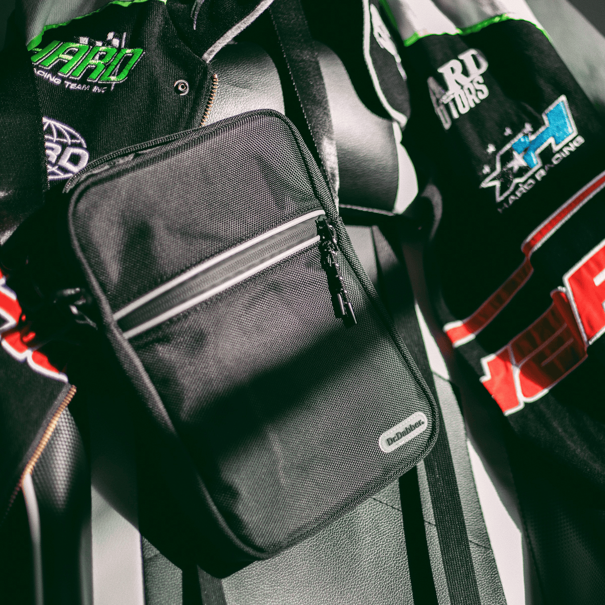 Dr. Dabber Tour Bag worn over a varsity jacket